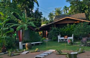 a house with a garden with a table and chairs at Jungle Garden Bungalows in Hinkong
