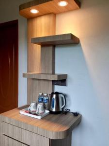 a kitchen with a counter with a coffee pot on it at Deluxe Room Mandahan Beach Garden in Kimanis