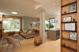 a living room and kitchen with a column in the middle at The home by the river in Bellano