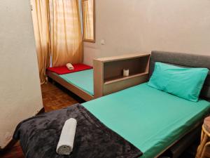Postel nebo postele na pokoji v ubytování Bayu Emas Batu Ferringhi Penang + 7 fotografií