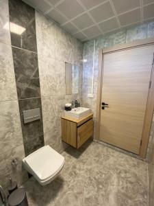 a bathroom with a toilet and a sink at Dalaman Çınar Apart in Dalaman +5 photos