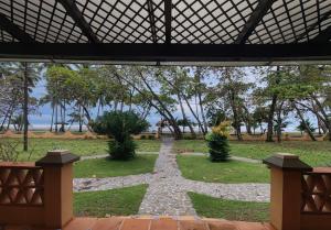 a view of a garden from the inside of a building at Marenaz Oceanfront Resort in Esterillos Este