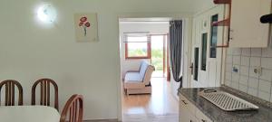 a kitchen and living room with a couch and a table at Guest House Kolić in Drežnik Grad