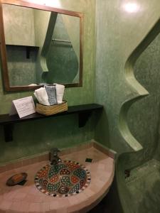 a bathroom with a mosaic sink and a mirror at Riad de charme L'Oasis d'Essaouira - Chambre Luxe en Terrasse in Essaouira