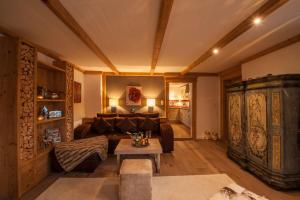 a living room with a couch and a table at Chalet Bucher in Ehrwald