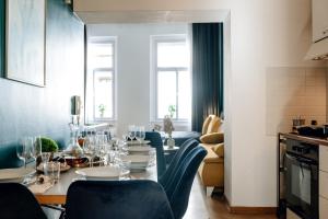 a dining room with a table and blue chairs at Wagnerstays Royal Billiard Residence in Prague +212 photos