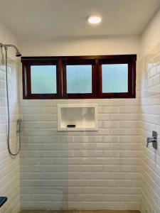 a bathroom with a shower and a window at Refúgio entre Mar e Montanha in Paraty +27 photos