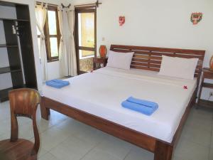 Postel nebo postele na pokoji v ubytování Mango Dive & Bungalow