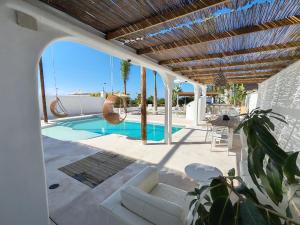 a villa with a swimming pool and a patio at VILLA8 in Puerto de Santiago