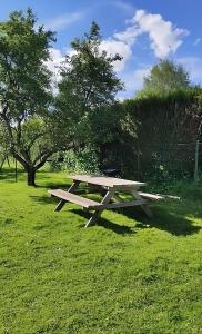 a picnic table sitting in the grass in a field at ~ Parenthèse bucolique ~ in Saint-Germain +10 photos