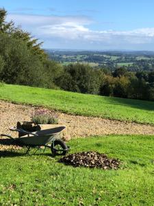 a wheelbarrow sitting on top of a grass field at The Stable in Sourdeval