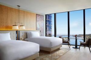 two beds in a hotel room with a view at The Ritz-Carlton, Perth in Perth