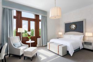 a bedroom with a bed and a desk and a chair at Hotel Bristol, A Luxury Collection Hotel, Warsaw in Warsaw