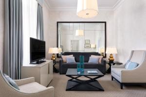 a living room with a couch and a tv at Hotel Bristol, A Luxury Collection Hotel, Warsaw in Warsaw