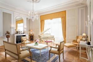 a living room with a piano and a table at Hotel Bristol, A Luxury Collection Hotel, Warsaw in Warsaw