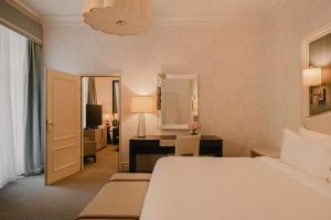 a bedroom with a bed and a desk in a room at Hotel Bristol, A Luxury Collection Hotel, Warsaw in Warsaw