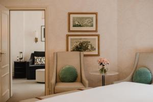 a bedroom with two chairs and a table and a couch at Hotel Bristol, A Luxury Collection Hotel, Warsaw in Warsaw