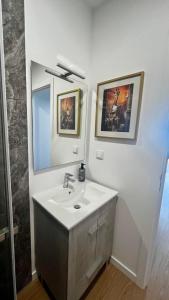a bathroom with a sink and a mirror at Anastacio Tiny House in Porto Moniz +18 photos