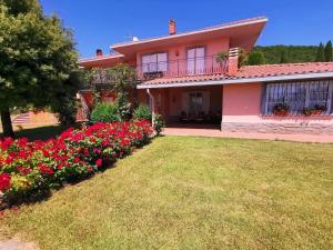 a house with flowers in front of a yard at Villa Montesegnale in Bolsena