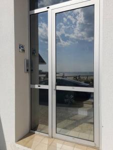 a sliding glass door with a view of the ocean at Appartement PONTAILLAC- ROYAN in Pontaillac