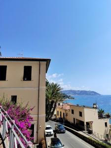 a street with cars parked on the side of a building at La Maddalena Room in Bordighera