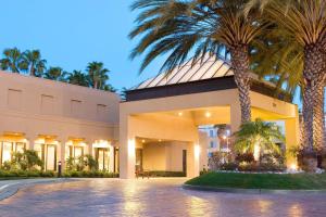 a building with palm trees in front of it at Courtyard Irvine John Wayne Airport/Orange County in Irvine