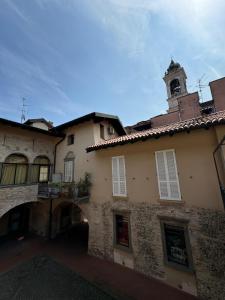 a building with a clock tower on top of it at Braguti Apartments in Romano di Lombardia +11 photos
