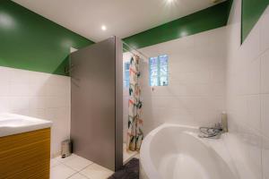 a bathroom with a tub and a sink at L'Ecrin d'Opale, la nature à proximité des sites incontournables in Audembert +29 photos