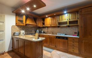a kitchen with wooden cabinets and granite counter tops at 2 Bedroom Stunning Home In Luino in Luino