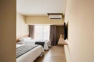 Voodi või voodid majutusasutuse Brown House Hotel - Taipei Main Station toas