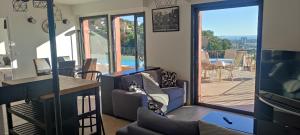 a living room with a view of a patio at T2 vue imprenable au calme in Nice