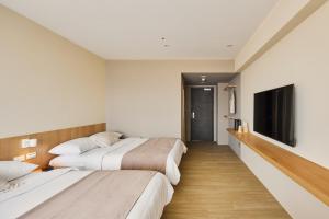 Voodi või voodid majutusasutuse Brown House Hotel - Taipei Main Station toas