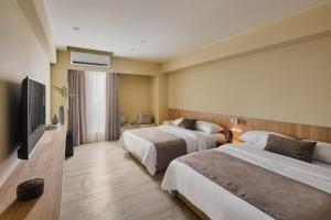 Voodi või voodid majutusasutuse Brown House Hotel - Taipei Main Station toas
