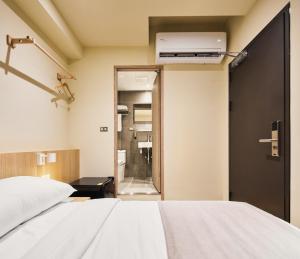 Voodi või voodid majutusasutuse Brown House Hotel - Taipei Main Station toas