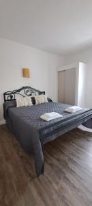 a large bed in a bedroom with a wooden floor at Casa Lila in Girona