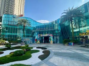 a large glass building with trees in front of it at Country Garden Danga Bay,Full Seaview, 6-8pax, Netflix in Johor Bahru