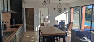 a kitchen and living room with a table and a dining room at T2 vue imprenable au calme in Nice +3 photos