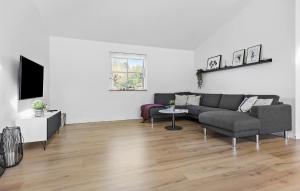 a living room with a couch and a tv at 3 Bedroom Nice Home In Vejby in Vejby