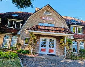 a hotel with a sign on the front of a building at Hotel Thesdorfer Hof in Pinneberg