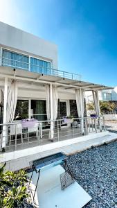 a house with a balcony and a swimming pool at Вилла в жилом комплексе Caesar Beach V16L in Boğaz +23 photos