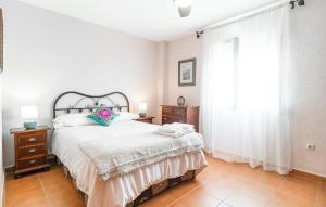 a white bedroom with a bed and a window at Pet Friendly Apartment in El Puerto de Santa María