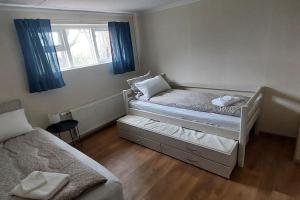 a small bedroom with two beds and a window at Grund in Rauðamelur