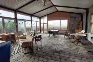 a large room with tables and chairs and windows at Grund in Rauðamelur