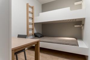 a small room with a bunk bed and a table at RukaHillChalet3 Ski In - Ski Out in Ruka