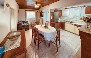 a kitchen and dining room with a table and chairs at Holiday Home Poplat 19 in Vela Luka
