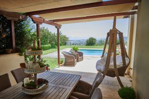 a porch with a hammock and a swing at Luxury Apartment with Pool in Pallini