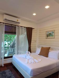 a bedroom with a bed with towels on it at Nangyuan Island Dive Resort in Ko Tao