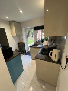 a kitchen with a sink and a counter top at Franky's Place luxury apartment in The Hyde