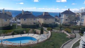 an aerial view of a yard with houses and a swimming pool at BarrancasdelGolfo in Puerto Madryn