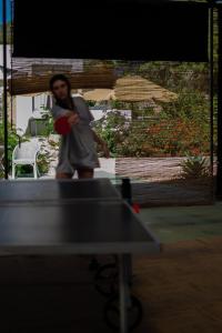 a man is playing a game of table tennis at La Pandilla Ibiza in Sant Francesc de s'Estany
